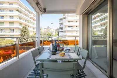 a table and chairs on a balcony with a view at Résidence 3p De Style à Deux Pas De La Croisette & Commerces - 3P de style à deux pas de la Croisette & commerces MAE-2103 in Cannes