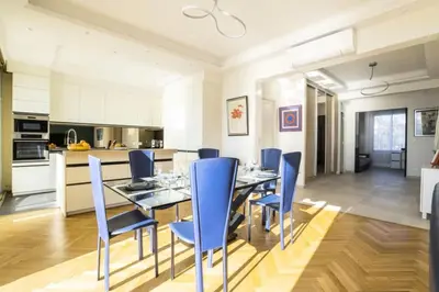a dining room with a glass table and blue chairs at Résidence 4p Vue Mer Exceptionnelle, Aux Pieds Des Plages - 4P vue mer exceptionnelle, aux pieds des plages MAE-2113 in Cannes