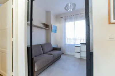 a living room with a couch and a window at Résidence 4p Vue Mer Exceptionnelle, Aux Pieds Des Plages - 4P vue mer exceptionnelle, aux pieds des plages MAE-2113 in Cannes