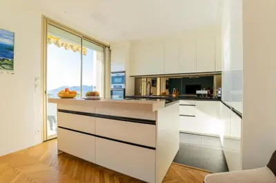 a kitchen with white cabinets and a large window at Résidence 4p Vue Mer Exceptionnelle, Aux Pieds Des Plages - 4P vue mer exceptionnelle, aux pieds des plages MAE-2113 in Cannes