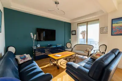 a living room with a couch and a table at Résidence 4p Vue Mer Exceptionnelle, Aux Pieds Des Plages - 4P vue mer exceptionnelle, aux pieds des plages MAE-2113 in Cannes