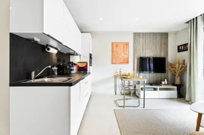 a kitchen with white cabinets and a sink at Résidence Centre Ville De Cannes, 2p Moderne Avec Terrasse - Centre ville de Cannes, 2P moderne avec terrasse MAE-2133 in Cannes