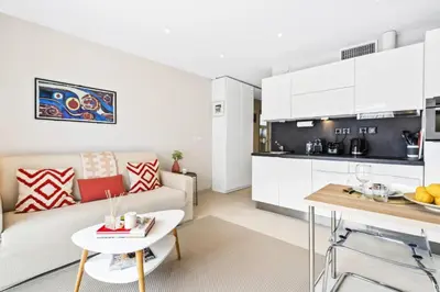 a living room and kitchen with a couch and a table at Résidence Centre Ville De Cannes, 2p Moderne Avec Terrasse - Centre ville de Cannes, 2P moderne avec terrasse MAE-2133 in Cannes