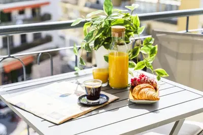 a table with a breakfast of coffee and croissants and orange juice at Résidence Centre Ville De Cannes, 2p Moderne Avec Terrasse - Centre ville de Cannes, 2P moderne avec terrasse MAE-2133 in Cannes