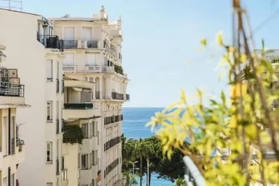 a view of buildings with the ocean in the background at Résidence Centre Ville De Cannes, 2p Moderne Avec Terrasse - Centre ville de Cannes, 2P moderne avec terrasse MAE-2133 in Cannes