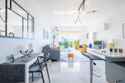 a kitchen and living room with a table and chairs at Résidence Rare ! Superbe 3 Pièces Avec Jardin Face à La Mer - RARE ! Superbe 3 pièces avec jardin face à la mer MAE-2143 in Cannes