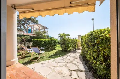 a patio with a chair and a garden at Résidence Rare ! Superbe 3 Pièces Avec Jardin Face à La Mer - RARE ! Superbe 3 pièces avec jardin face à la mer MAE-2143 in Cannes