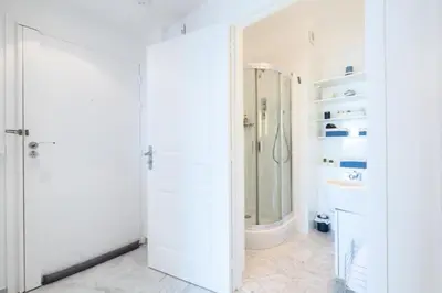 a white bathroom with a shower and a toilet at Résidence Rare ! Superbe 3 Pièces Avec Jardin Face à La Mer - RARE ! Superbe 3 pièces avec jardin face à la mer MAE-2143 in Cannes