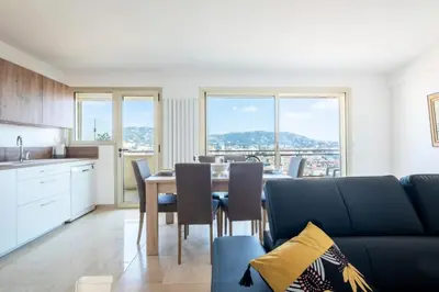 a kitchen and dining room with a table and chairs at Résidence 4p Proche Hyper Centre, Vue Mer, Parking - 4P proche hyper centre, vue mer, parking MAE-2153 in Cannes