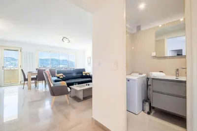 a kitchen and living room with a couch and a table at Résidence 4p Proche Hyper Centre, Vue Mer, Parking - 4P proche hyper centre, vue mer, parking MAE-2153 in Cannes