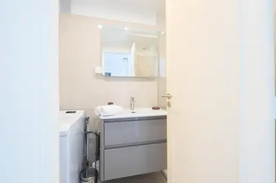 a white bathroom with a sink and a mirror at Résidence 4p Proche Hyper Centre, Vue Mer, Parking - 4P proche hyper centre, vue mer, parking MAE-2153 in Cannes