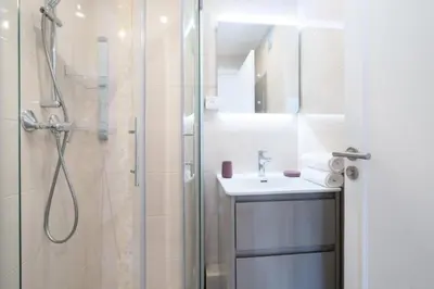 a bathroom with a shower and a sink and a mirror at Résidence 4p Proche Hyper Centre, Vue Mer, Parking - 4P proche hyper centre, vue mer, parking MAE-2153 in Cannes