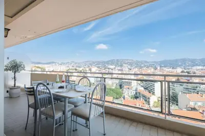 a dining room with a table and chairs and a large window at Résidence 4p Proche Hyper Centre, Vue Mer, Parking - 4P proche hyper centre, vue mer, parking MAE-2153 in Cannes