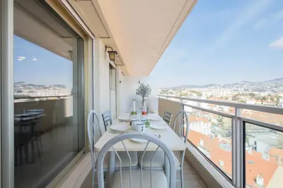 a balcony with a table and chairs and a view at Résidence 4p Proche Hyper Centre, Vue Mer, Parking - 4P proche hyper centre, vue mer, parking MAE-2153 in Cannes
