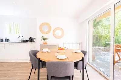 a kitchen and dining room with a wooden table and chairs at Résidence 3p Avec Jardin Près De La Croisette - 3p avec jardin près de la Croisette MAE-2173 in Cannes