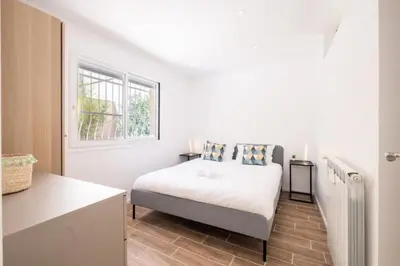 a white bedroom with a bed and a window at Résidence 3p Avec Jardin Près De La Croisette - 3p avec jardin près de la Croisette MAE-2173 in Cannes