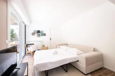 a white room with a bed and a chair at Résidence 3p Avec Jardin Près De La Croisette - 3p avec jardin près de la Croisette MAE-2173 in Cannes