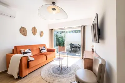 a living room with a couch and a table at Résidence Appartement Avec Piscine Résidentiel - Appartement avec piscine résidentiel MAE-2183 in Cannes