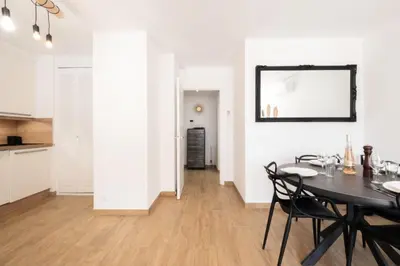 a dining room with a table and a mirror on the wall at Résidence Appartement Avec Piscine Résidentiel - Appartement avec piscine résidentiel MAE-2183 in Cannes