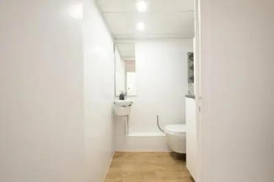 a white bathroom with a toilet and a sink at Résidence Appartement Avec Piscine Résidentiel - Appartement avec piscine résidentiel MAE-2183 in Cannes