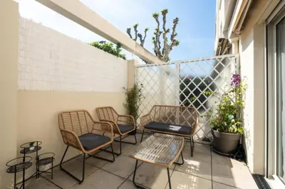 a group of chairs and tables on a balcony at Résidence Appartement Avec Piscine Résidentiel - Appartement avec piscine résidentiel MAE-2183 in Cannes