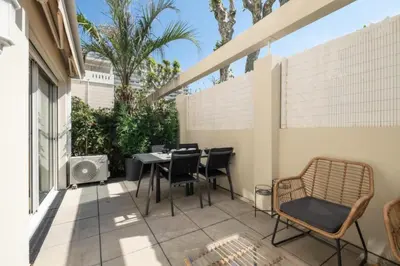 a patio with a table and chairs on a balcony at Résidence Appartement Avec Piscine Résidentiel - Appartement avec piscine résidentiel MAE-2183 in Cannes