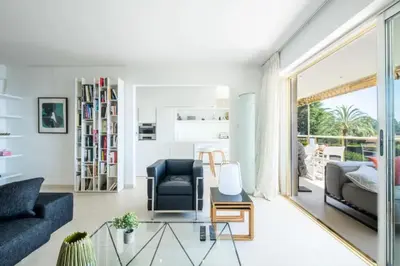 a living room with a couch and a glass table at Résidence 3p, Terrasse Aménagée, Piscine, Vue Sur Les îles - 3P, terrasse aménagée, piscine, vue sur les îles MAE-2193 in Cannes