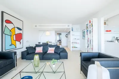 a living room with two blue couches and a table at Résidence 3p, Terrasse Aménagée, Piscine, Vue Sur Les îles - 3P, terrasse aménagée, piscine, vue sur les îles MAE-2193 in Cannes