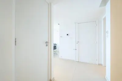 a hallway with white walls and a glass door at Résidence 3p, Terrasse Aménagée, Piscine, Vue Sur Les îles - 3P, terrasse aménagée, piscine, vue sur les îles MAE-2193 in Cannes