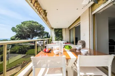 a dining room with a table and chairs on a balcony at Résidence 3p, Terrasse Aménagée, Piscine, Vue Sur Les îles - 3P, terrasse aménagée, piscine, vue sur les îles MAE-2193 in Cannes