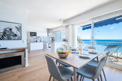 a kitchen and dining room with a table and chairs at Résidence Rare ! 3p En Front De Mer - RARE ! 3P en front de mer MAE-2213 in Cannes