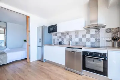 a kitchen with a stove and a refrigerator at Résidence Rare ! 3p En Front De Mer - RARE ! 3P en front de mer MAE-2213 in Cannes