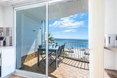 a balcony with a table and a view of the ocean at Résidence Rare ! 3p En Front De Mer - RARE ! 3P en front de mer MAE-2213 in Cannes