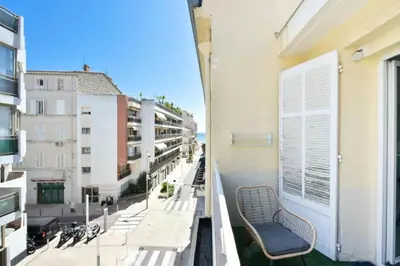a balcony with benches and a view of a city at Résidence 2p Hyper Centre Cannes, 100 Plages - 2P hyper centre Cannes, 100 plages MAE-2223 in Cannes