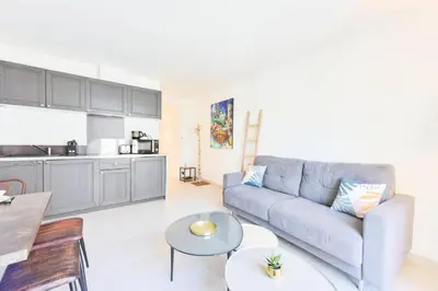 a living room with a couch and a table at Résidence 2p Hyper Centre Cannes, 100 Plages - 2P hyper centre Cannes, 100 plages MAE-2223 in Cannes