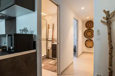 a kitchen and a living room with a mirror at Résidence 2p Hyper Centre Cannes, 100 Plages - 2P hyper centre Cannes, 100 plages MAE-2223 in Cannes