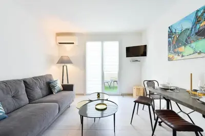 a living room with a couch and a table at Résidence 2p Hyper Centre Cannes, 100 Plages - 2P hyper centre Cannes, 100 plages MAE-2223 in Cannes