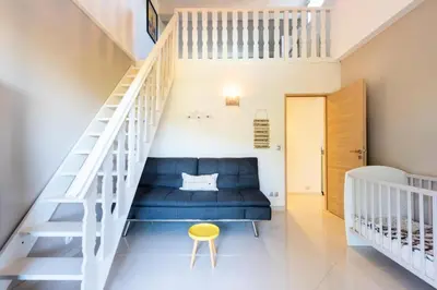 a living room with a blue couch and stairs at Résidence Villa 330m2, 6 Chambres, Piscine Chauffée Jacuzzi - Villa 330m2, 6 chambres, piscine chauffée jacuzzi MAE-2233 in Vallauris