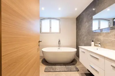 a bathroom with a large tub and two sinks at Résidence Villa 330m2, 6 Chambres, Piscine Chauffée Jacuzzi - Villa 330m2, 6 chambres, piscine chauffée jacuzzi MAE-2233 in Vallauris