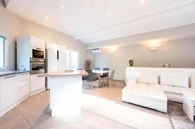 a kitchen and living room with a couch and a table at Résidence Villa 330m2, 6 Chambres, Piscine Chauffée Jacuzzi - Villa 330m2, 6 chambres, piscine chauffée jacuzzi MAE-2233 in Vallauris