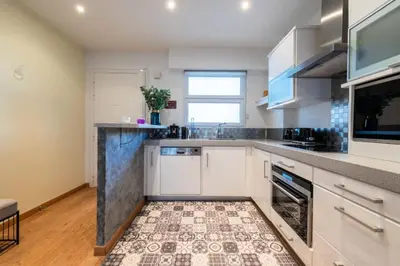 a kitchen with white cabinets and a tile floor at Résidence 3p Avec Terrasse Vue Mer, Face Au Martinez - 3P avec terrasse vue mer, face au Martinez MAE-2243 in Cannes