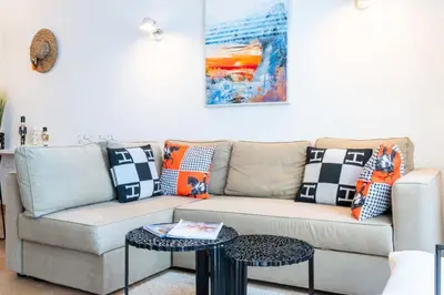 a living room with a couch with pillows on it at Résidence 3p Avec Terrasse Vue Mer, Face Au Martinez - 3P avec terrasse vue mer, face au Martinez MAE-2243 in Cannes