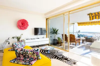 a living room with a yellow couch and a television at Résidence 3p Haut De Gamme En Résidence Avec Piscine ! - 3P haut de gamme en résidence avec piscine ! MAE-2253 in Cannes