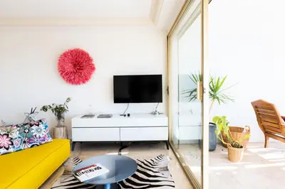 a living room with a yellow couch and a tv at Résidence 3p Haut De Gamme En Résidence Avec Piscine ! - 3P haut de gamme en résidence avec piscine ! MAE-2253 in Cannes