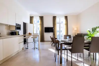 a kitchen and dining room with a table and chairs at Résidence 3 Pièces Rue D’antibes à Deux Pas Du Palais Des Festivals - 3 pièces rue d’Antibes à deux pas du Palais des festivals MAE-2263 in Cannes