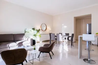 a living room with a couch and chairs and a table at Résidence 3 Pièces Rue D’antibes à Deux Pas Du Palais Des Festivals - 3 pièces rue d’Antibes à deux pas du Palais des festivals MAE-2263 in Cannes