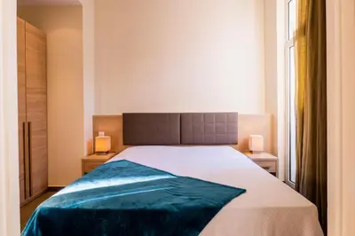 a bedroom with a large bed and two lamps at Résidence 3 Pièces Rue D’antibes à Deux Pas Du Palais Des Festivals - 3 pièces rue d’Antibes à deux pas du Palais des festivals MAE-2263 in Cannes