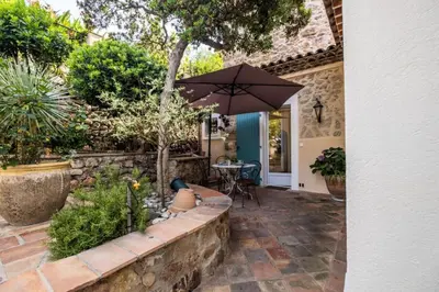 a patio with a table and an umbrella at Résidence Superbe Villa Avec Piscine & Sauna - Superbe villa avec piscine & sauna MAE-2283 in Cannes