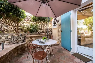 a table with chairs and an umbrella on a patio at Résidence Superbe Villa Avec Piscine & Sauna - Superbe villa avec piscine & sauna MAE-2283 in Cannes