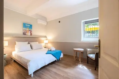 a bedroom with a bed and a table and a window at Résidence Superbe Villa Avec Piscine & Sauna - Superbe villa avec piscine & sauna MAE-2283 in Cannes
